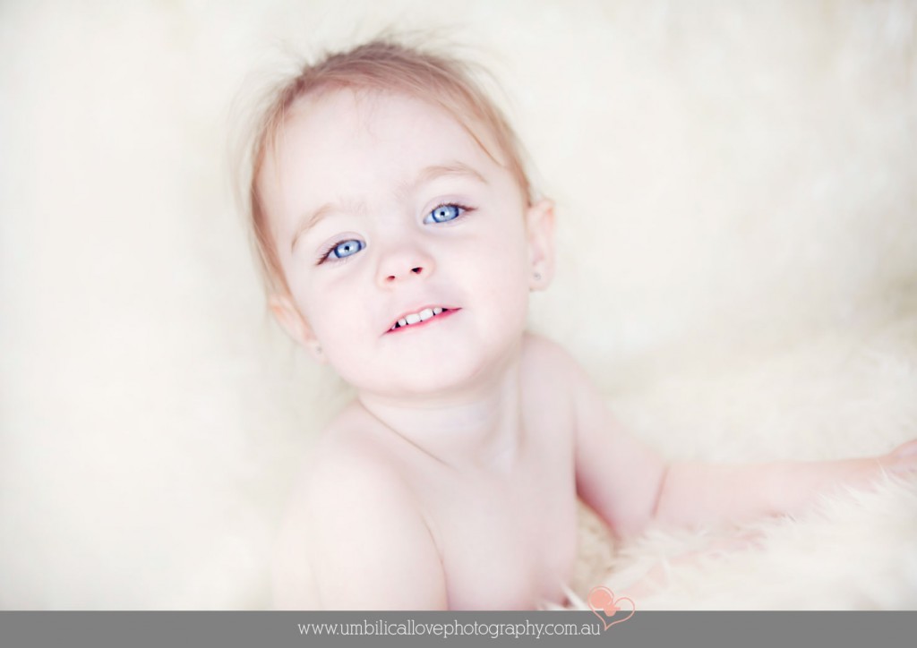 2 year old looking at the camera with her big blue eyes