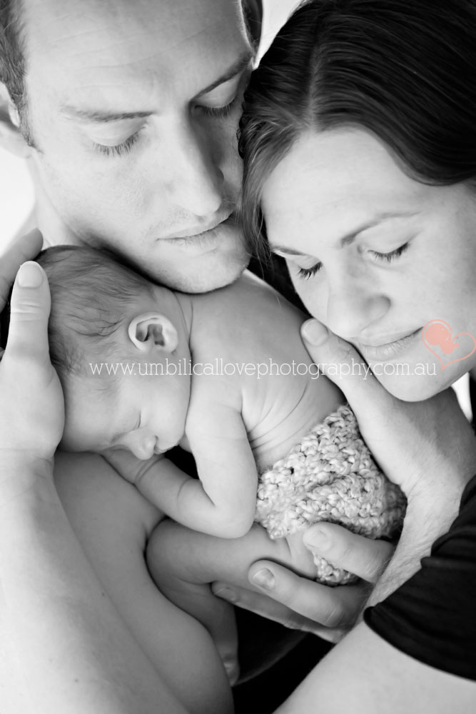 family photographer sunshine coast mum and dad snuggling sleeping newborn close