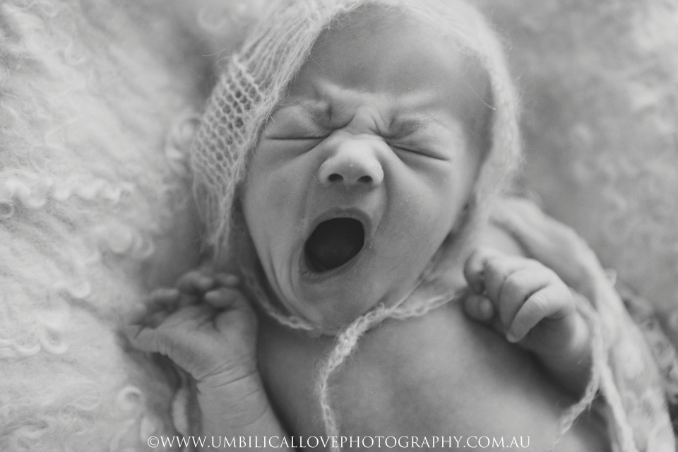 Newborn-Baby-Photographer-Wagga-Wagga black and white image of a baby yawning