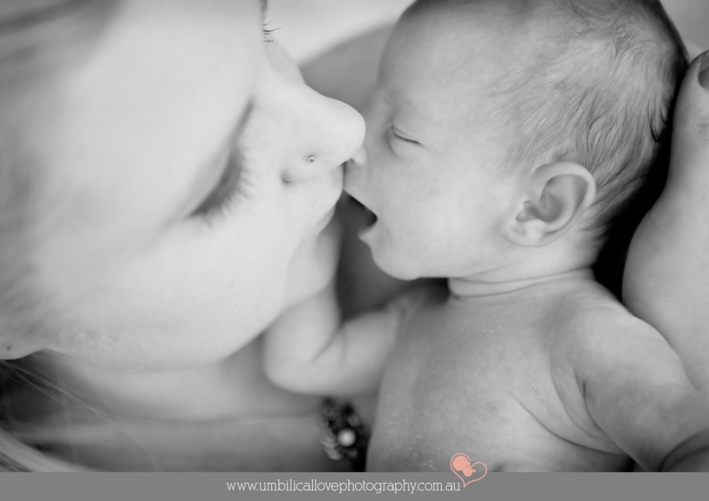 mum kisses her new baby