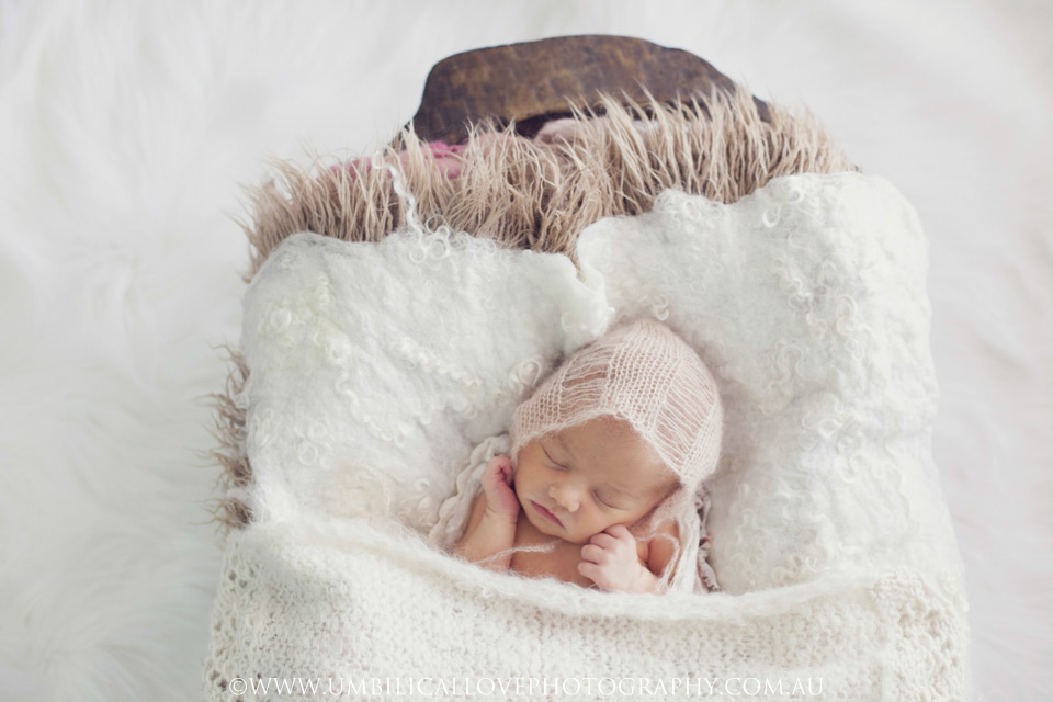 Newborn-Baby-Photography-Wagga-Wagga newborn baby asleep with a knitted cap on her head