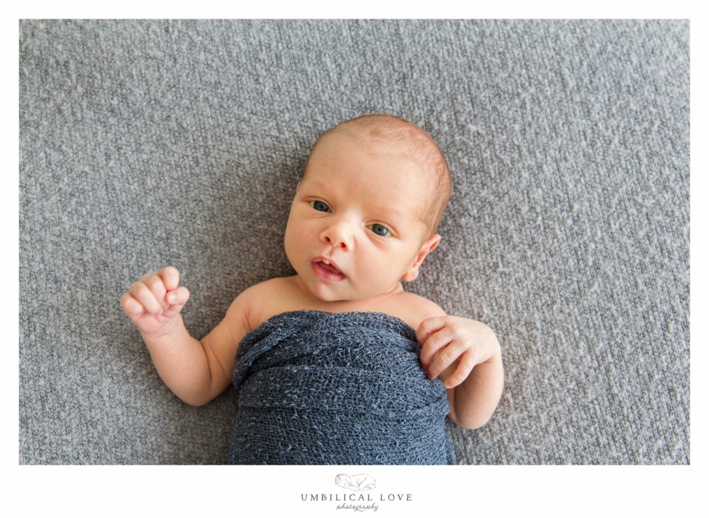 Baby wrapped in blue blanket