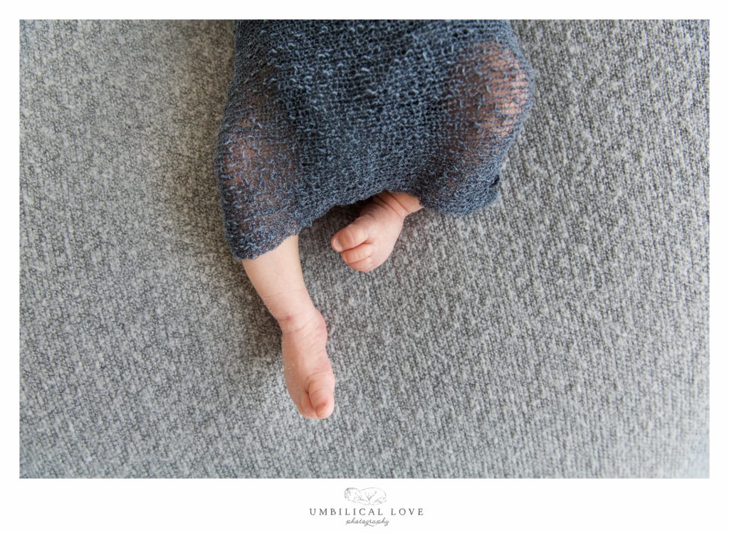 Baby toes wrapped in blue blanket