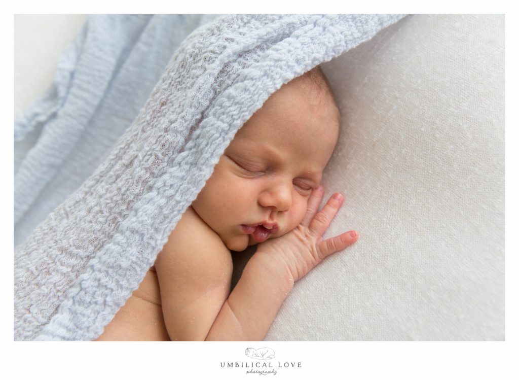Baby with sheet over head