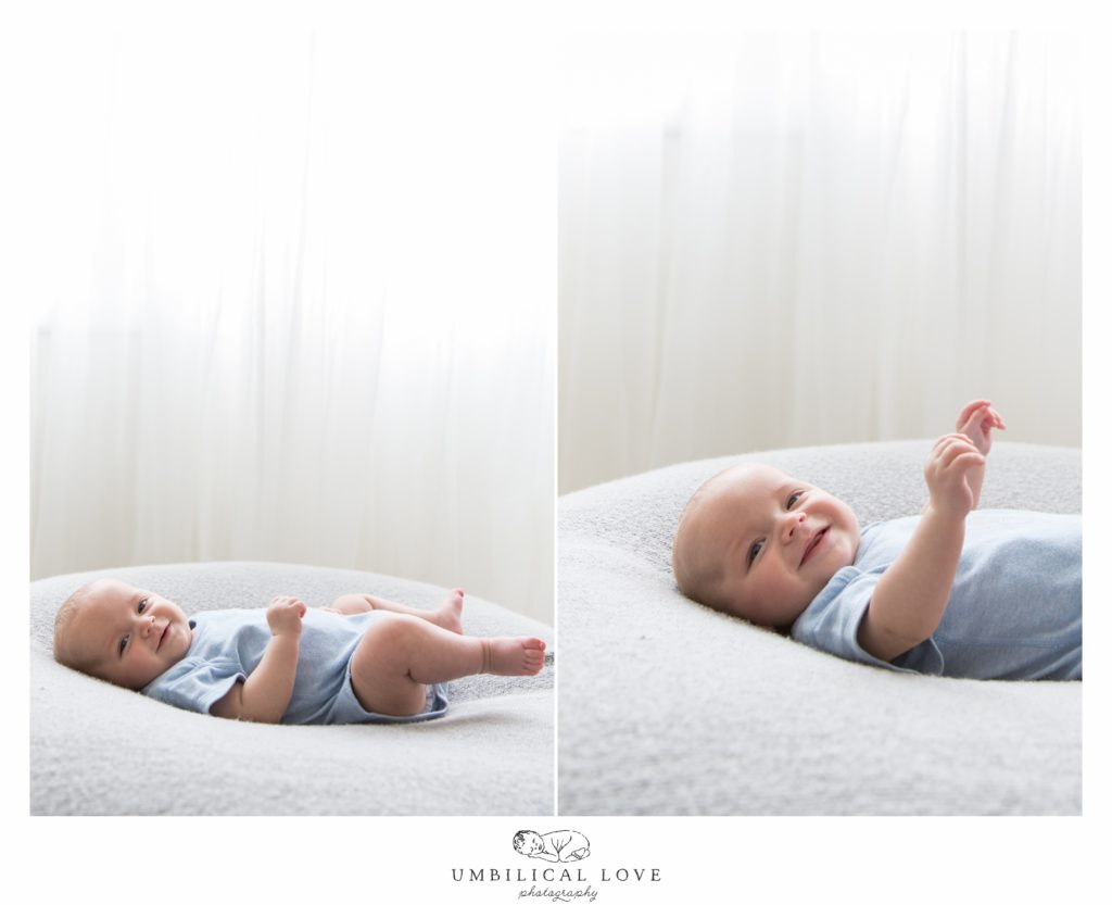 baby boy laying on bean bag smiling at camera
