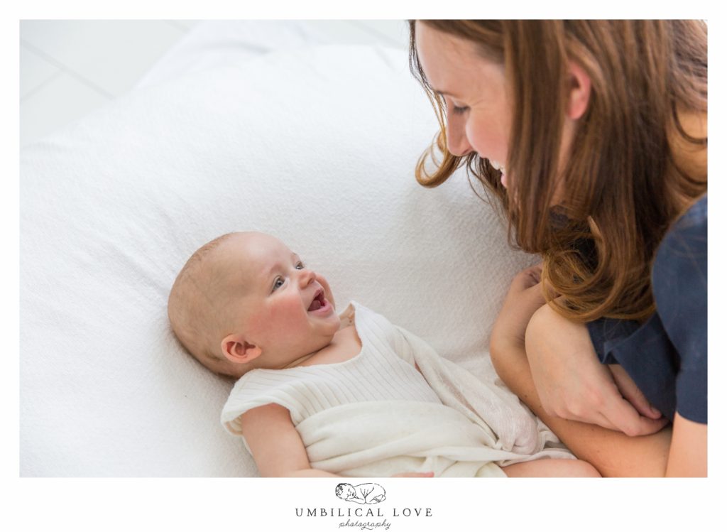 Baby boy laughing at mum