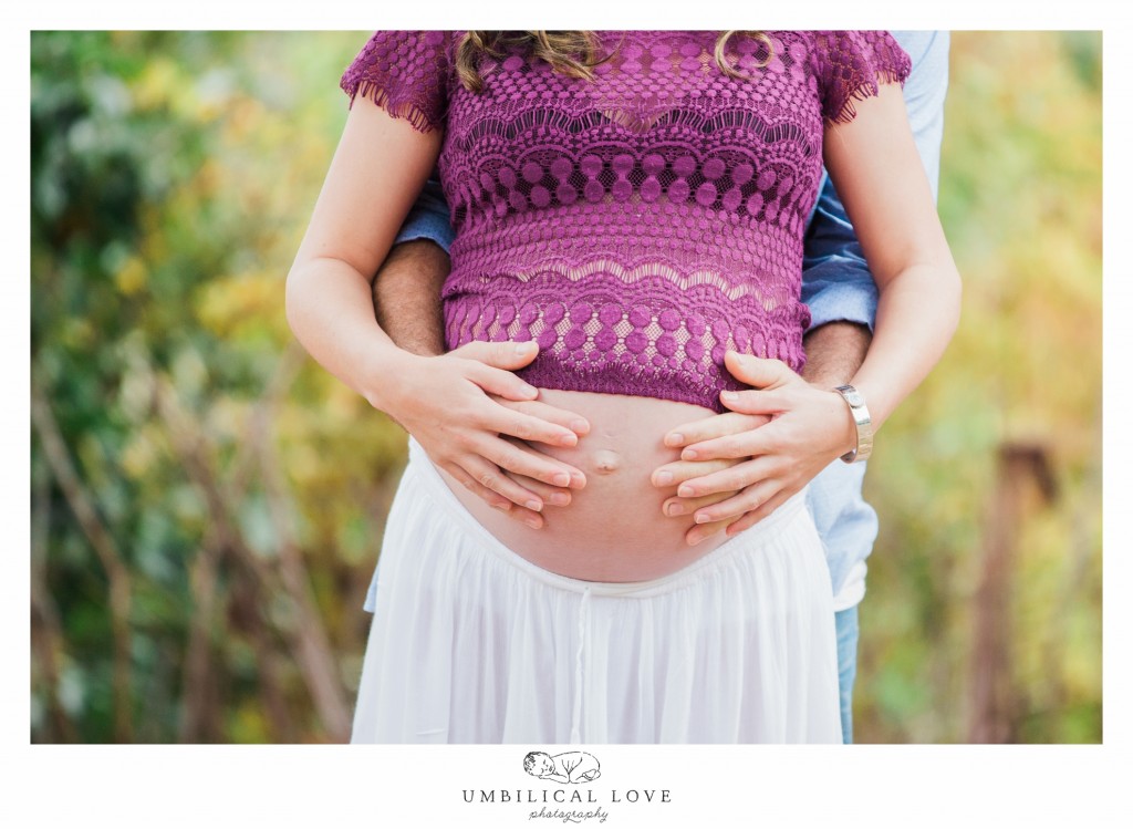 Dad to be holding mums pregnant belly