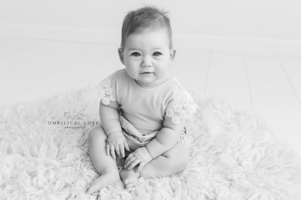 Little one year old smiles at camera