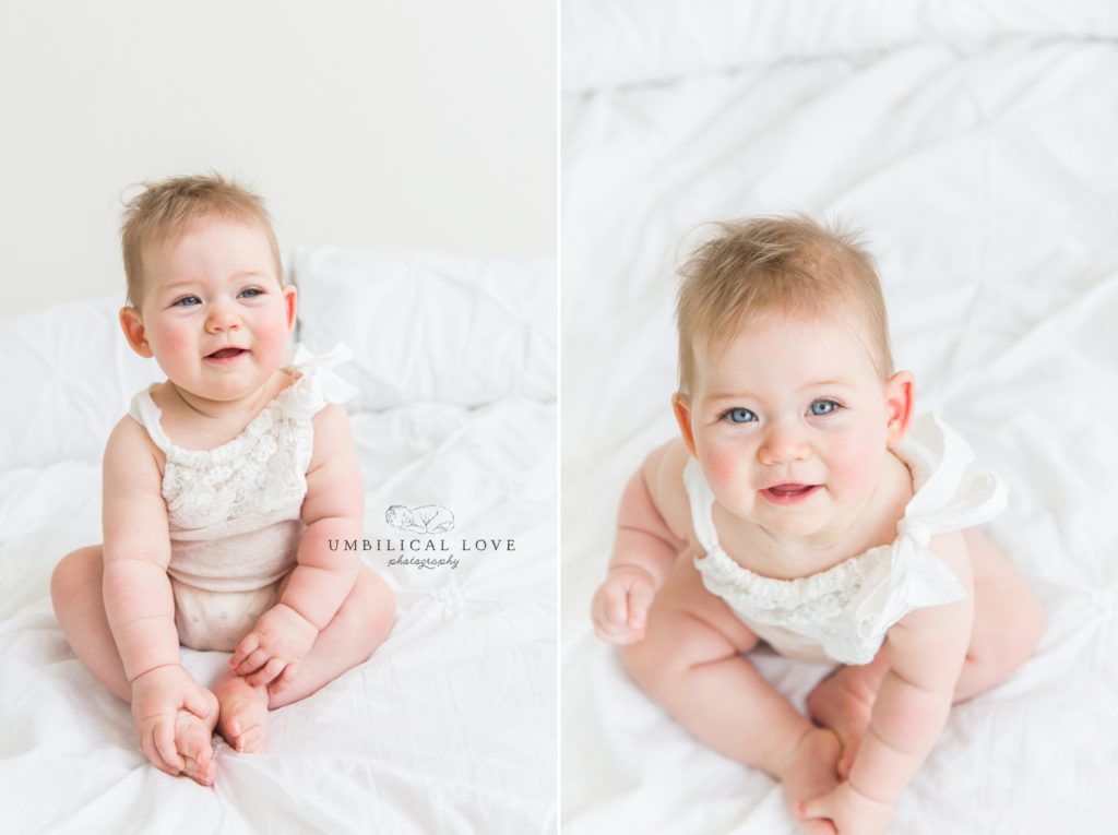 Baby looks up at camera with big blue eyes