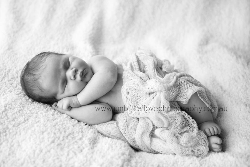 new baby wrapped up in a knitted wrap asleep