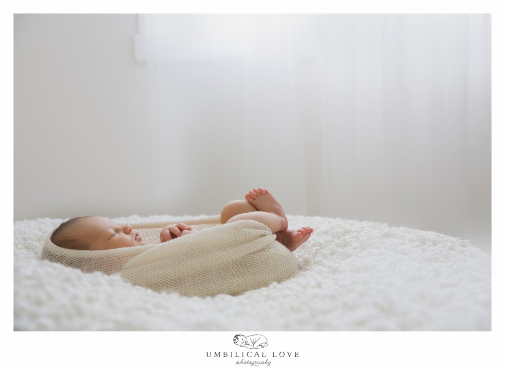 beautiful newborn girl sleeping on beanbag under the window 