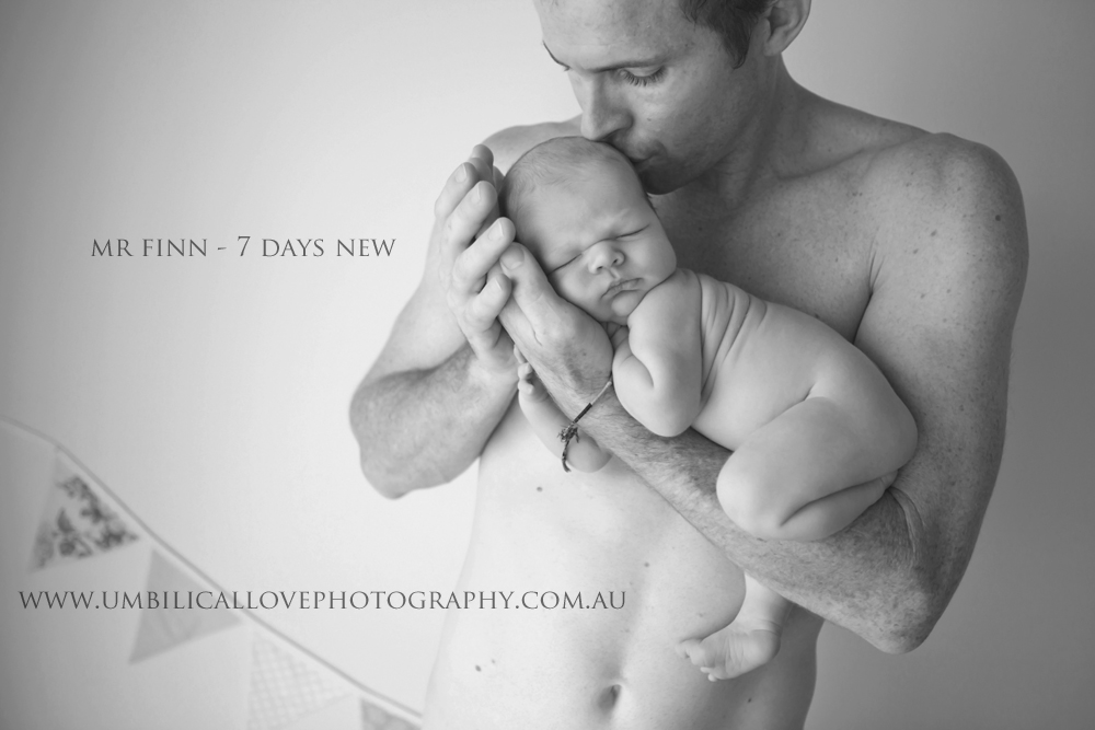 Albury - Wodonga Newborn Photographer dad holding his brand new baby hissing his head