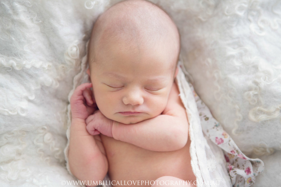Wagga-Wagga-Photographer-Newborn-Baby baby circled in a white knitted wrap sleeping