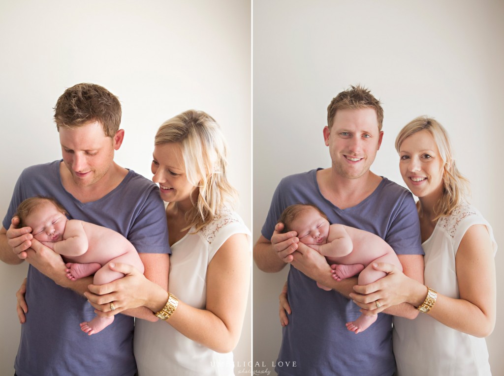 parents holding their newborn smiling at the camera