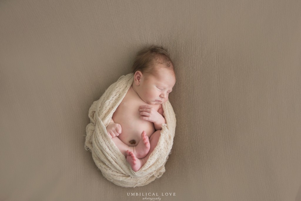 baby wrapped in a cream blanket cocoon