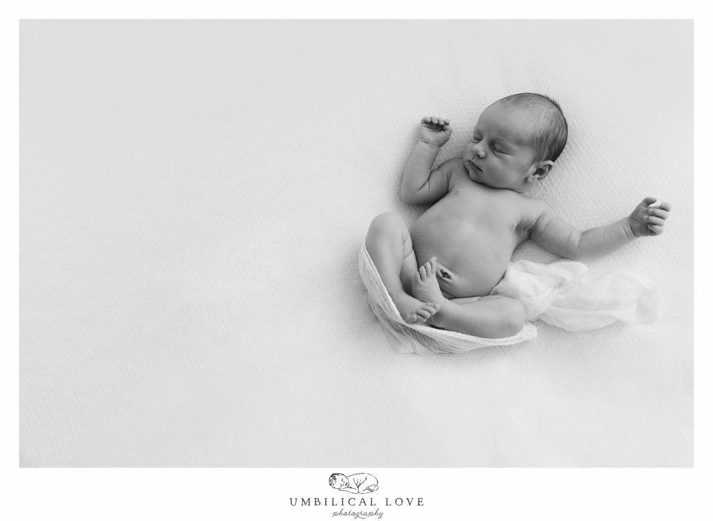 Newborn baby with arms out relaxed