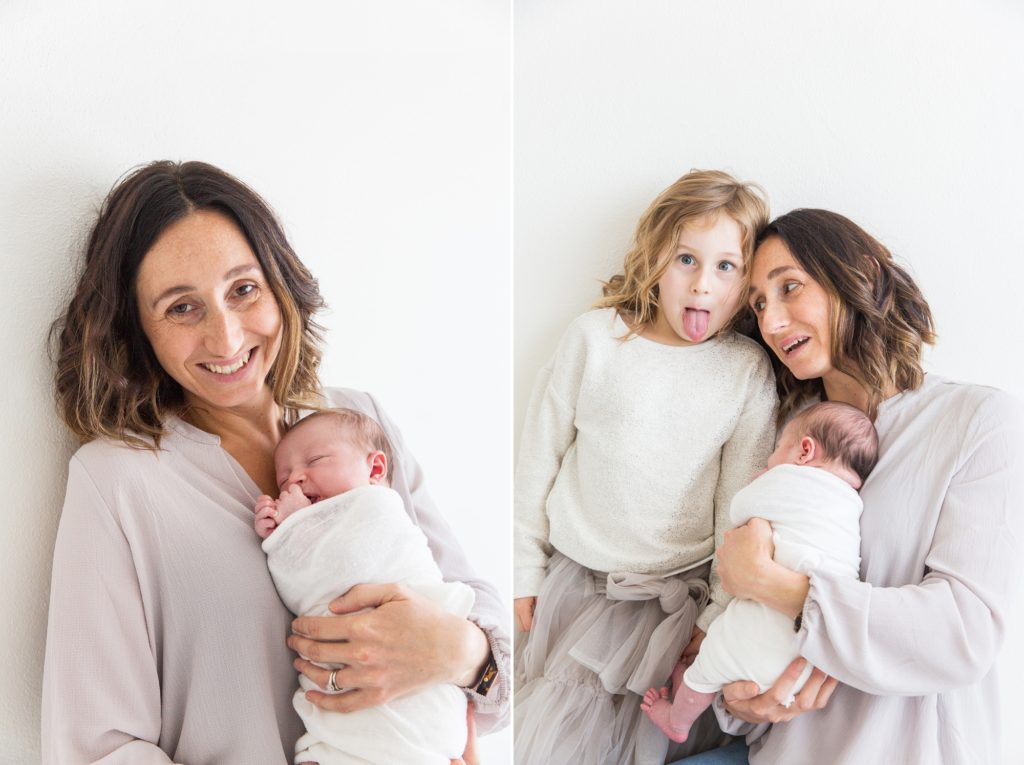 Big sister pulls a funny face in the photo with her newborn sister