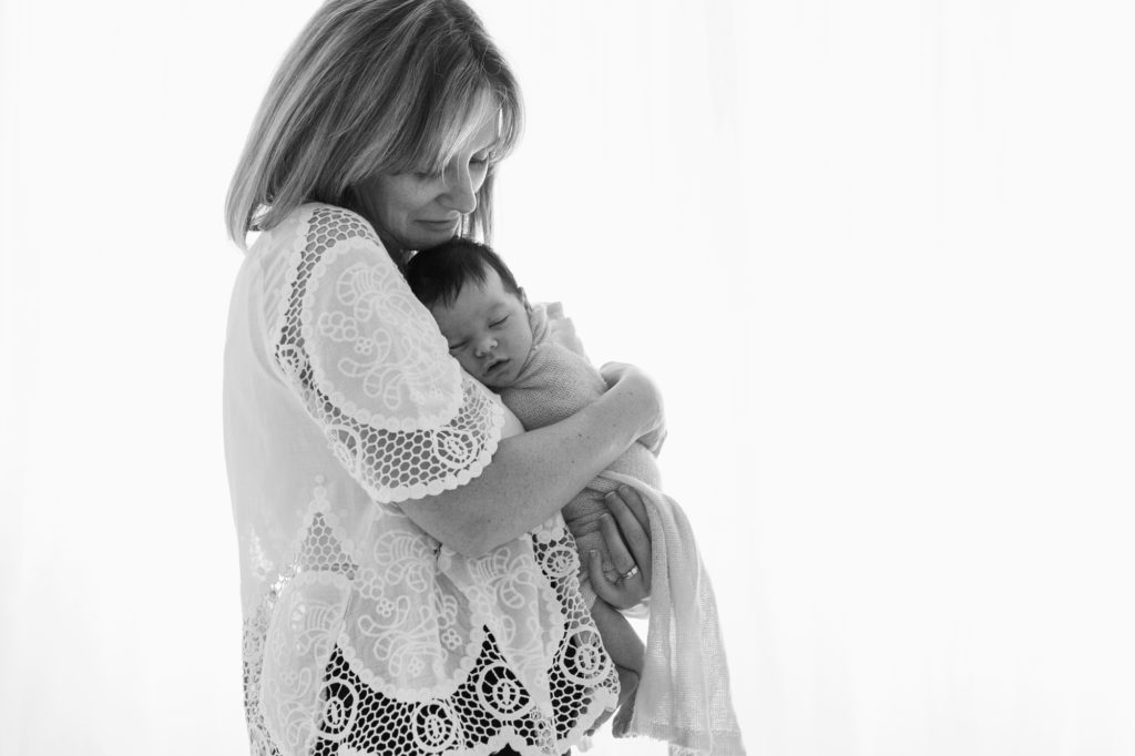 Mum comforts her newborn baby girl