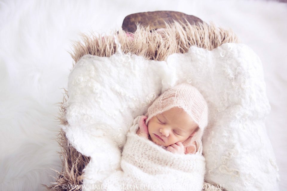 Wagga-Wagga-Photographer-Newborn-Baby sleeping baby fully wrapped in wooden cradle