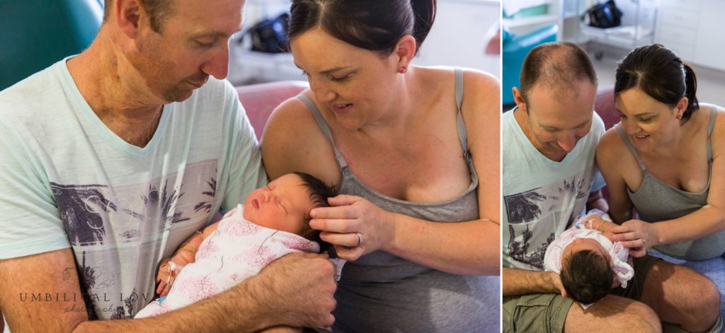Mum and dad look down at new baby daughter