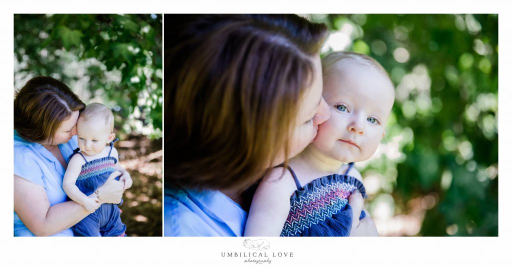 mum kissing baby and baby looks at camera