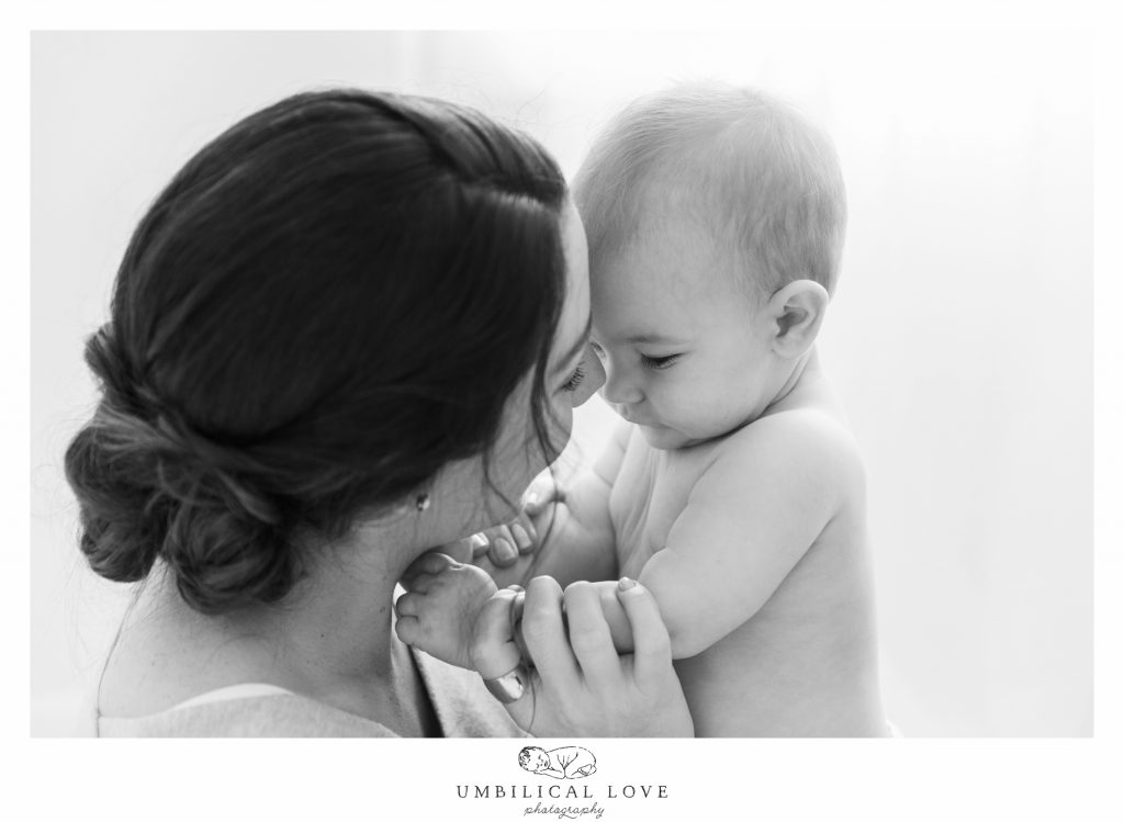 mum and bub with heads together