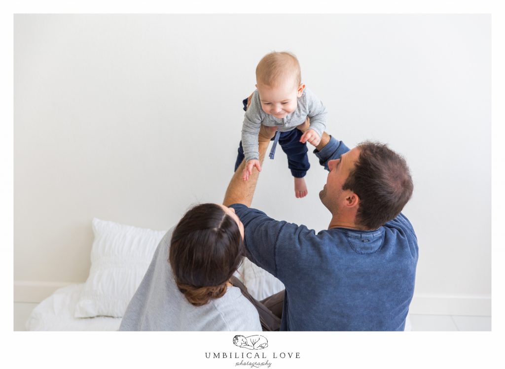 dad throws baby son up in the air