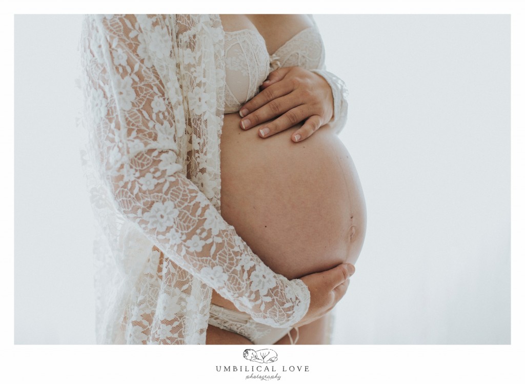 Mum to be holding pregnant belly