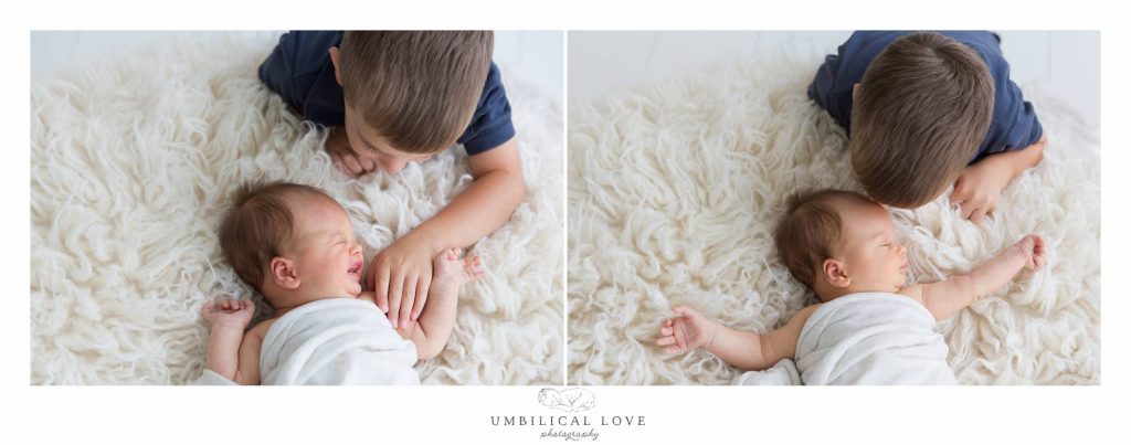 big brother holding his sisters hand and giving her a kiss when she crys
