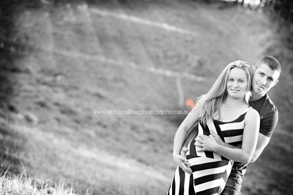 beautiful pregnant lady looking at the camera in a field