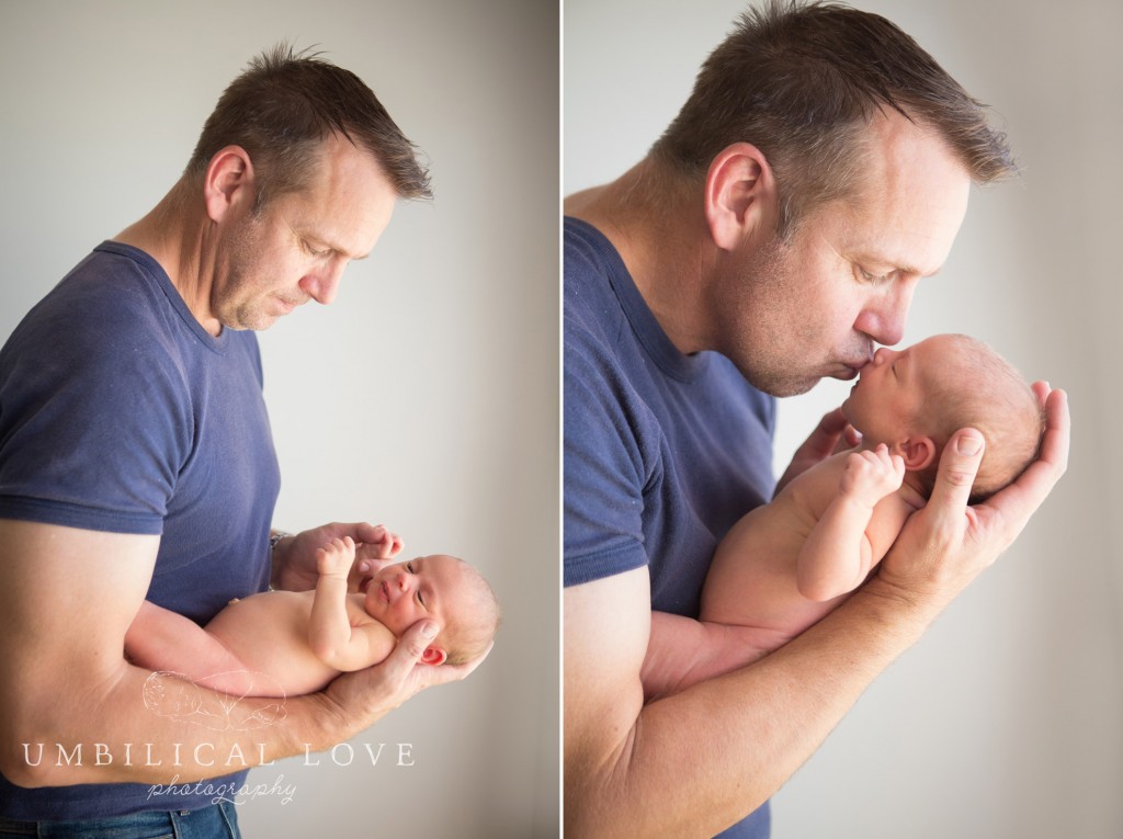 doting father kissing his newborn daughter