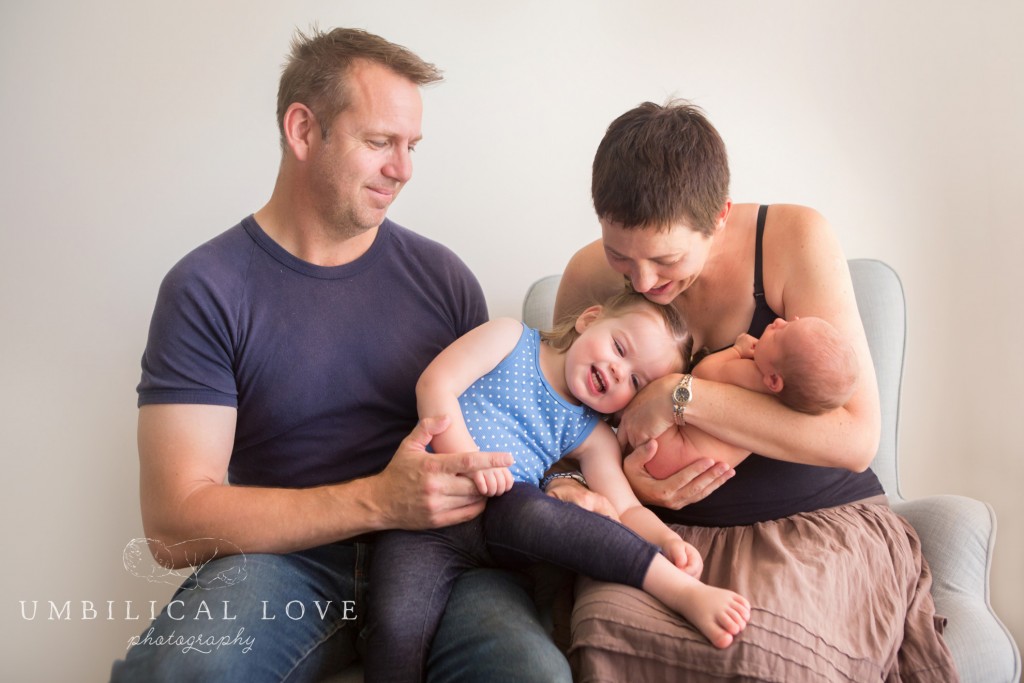 family portrait of mother father sister and newborn