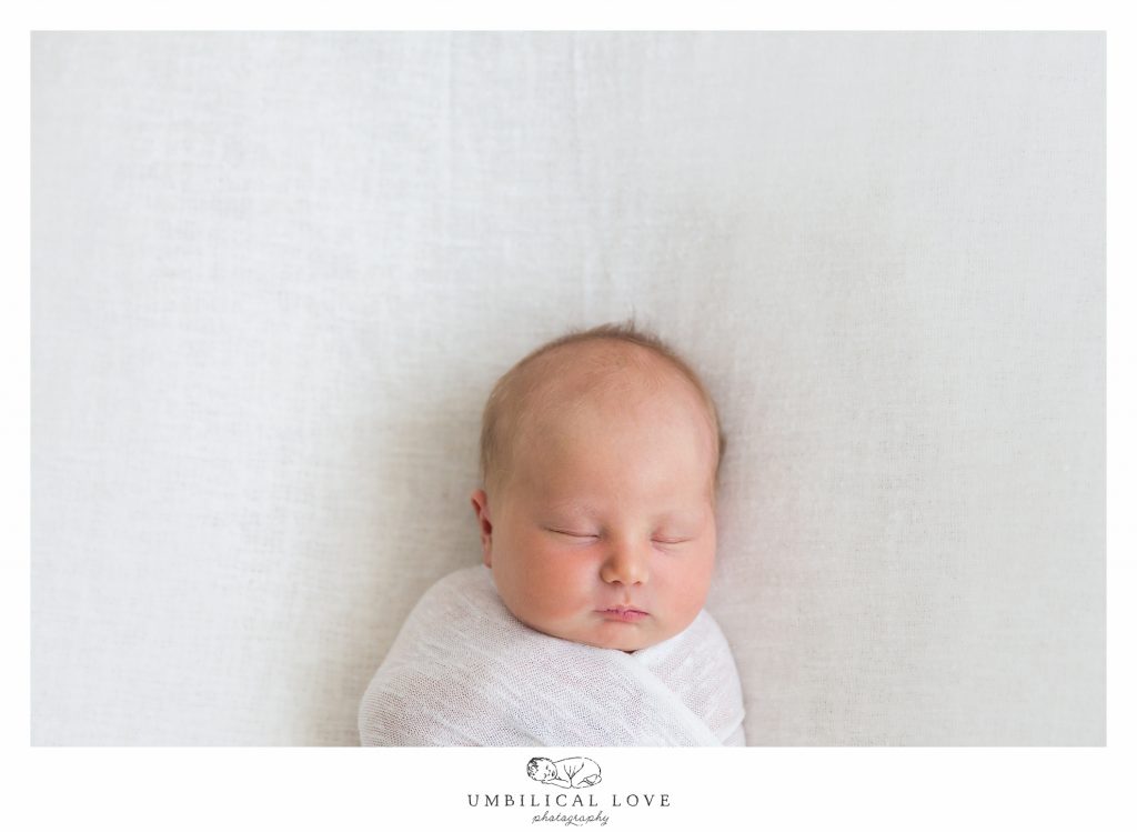 newborn baby naturally sleeping on blanket