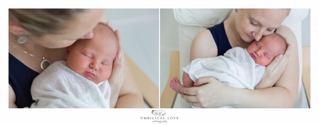 mum kissing newborn daughter on head