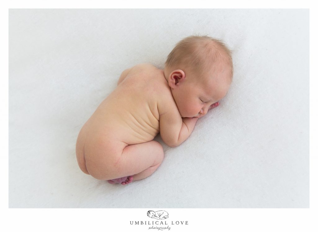 Newborn curled up in womb like fashion