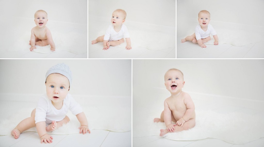White room entered with a baby boy smiling and looking at the camera with a blue beanie on