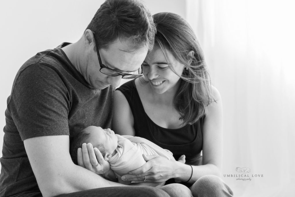 Mum and Dad look down at their new baby girl