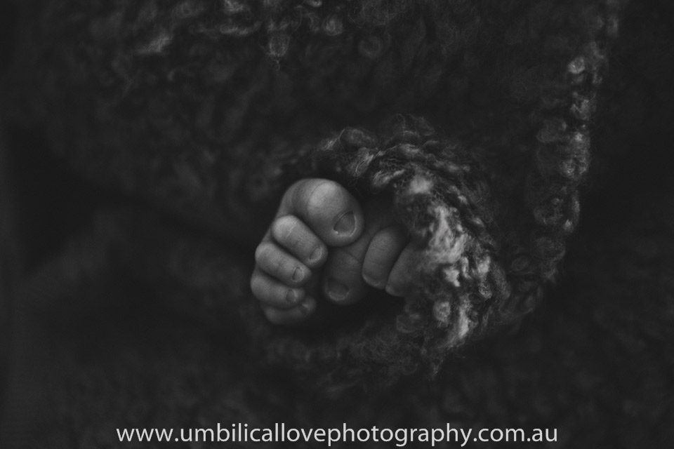 black and white close up of babys foot