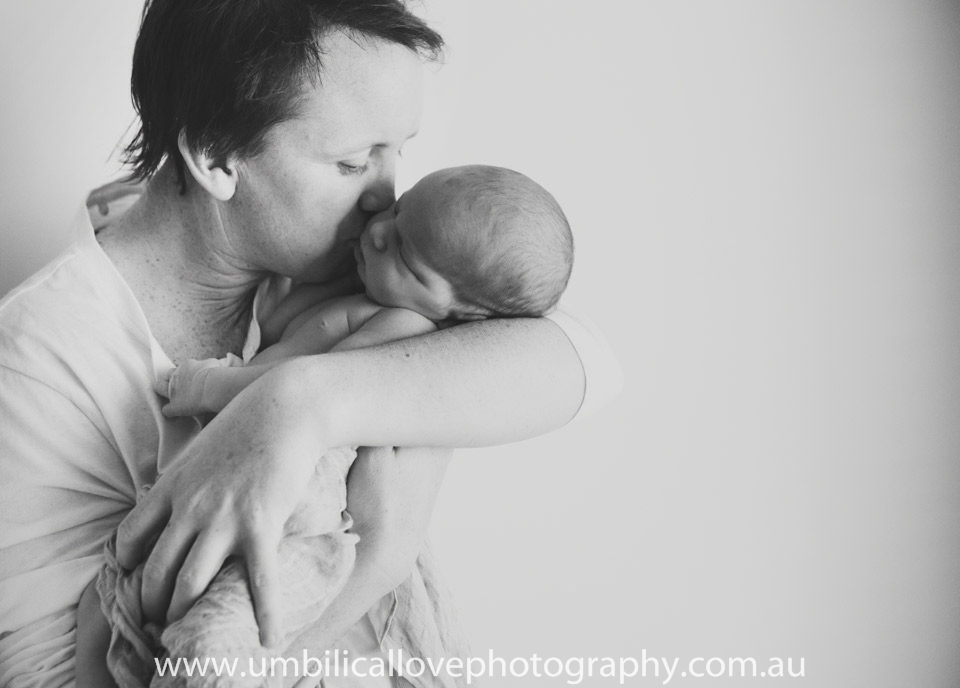 father kissing his sleeping baby on the cheek