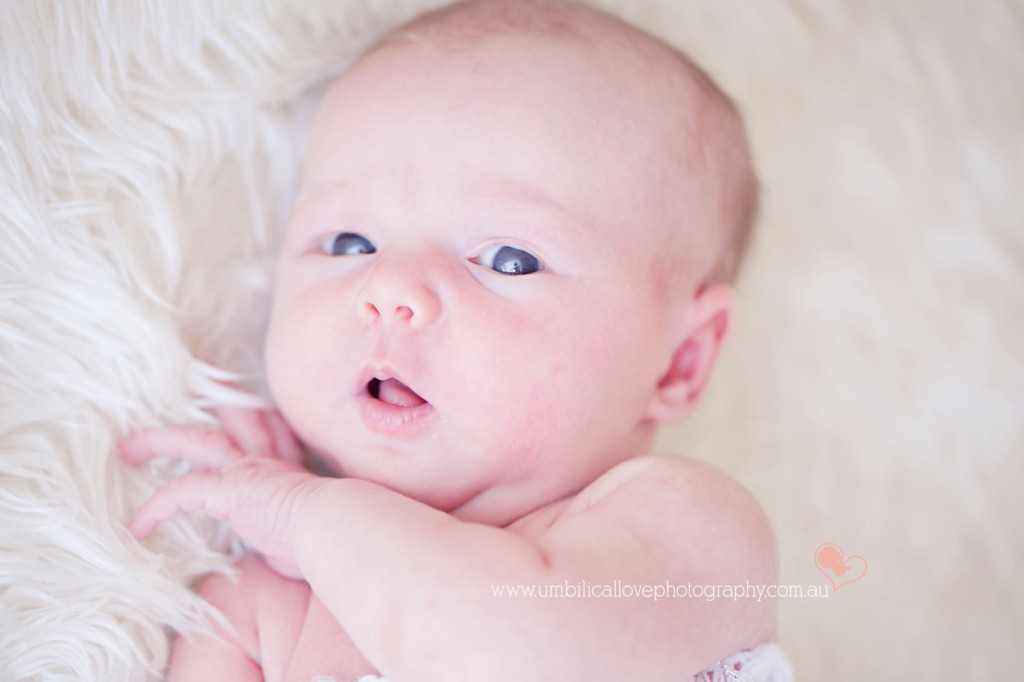 baby looking at camera with eyes wide open