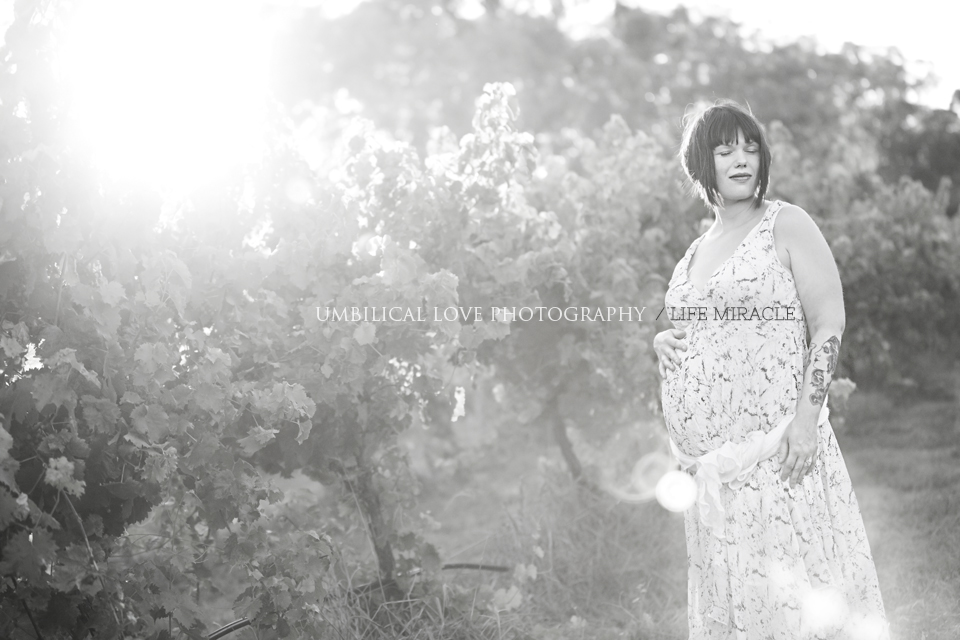 a pregnant woman with her eyes closed taking in the special time