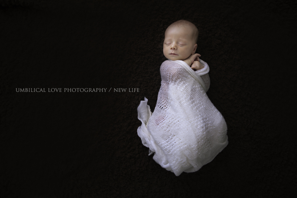 a newborn baby naturally wrapped 
