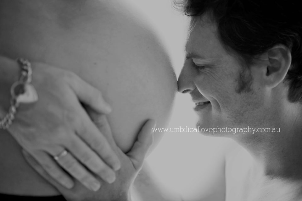 Dad to be putting his nose on mums bellybutton 