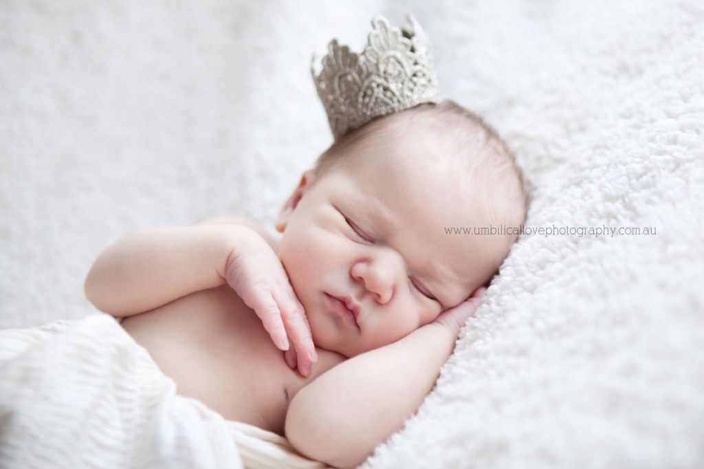 New-baby-photos-on-the-sunshine-coast-sippy-downs new baby sleeping on her hand with other hand touching her tiny face