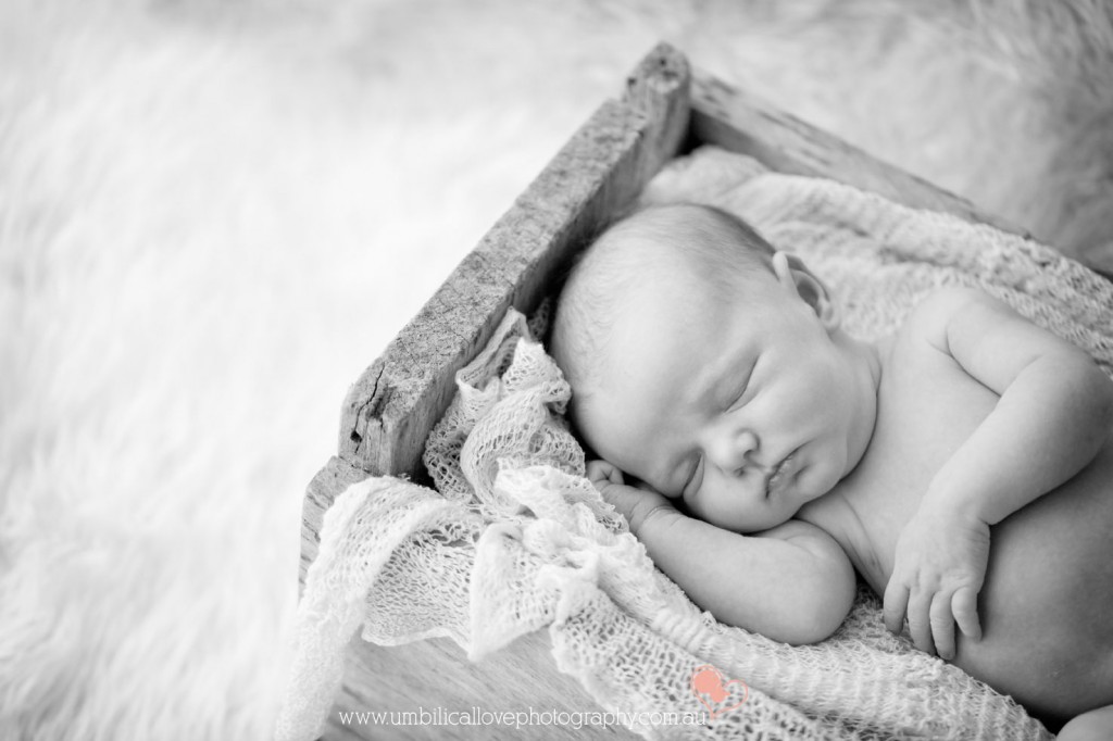 baby sleeping in a antique tool box