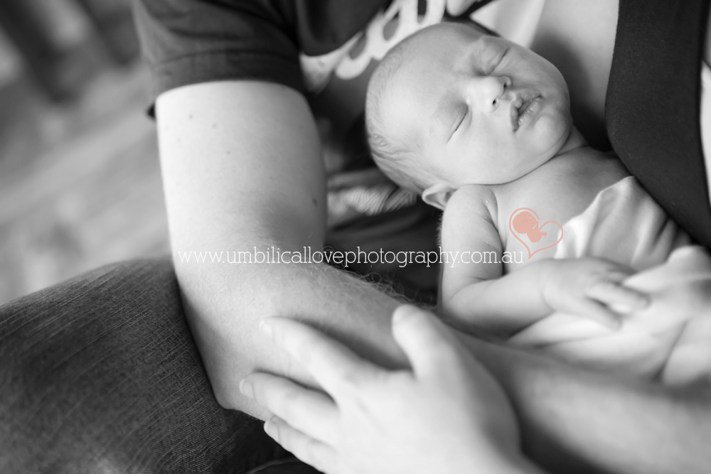 baby photographer sunshine coast mum and dad holding baby tightly in arms