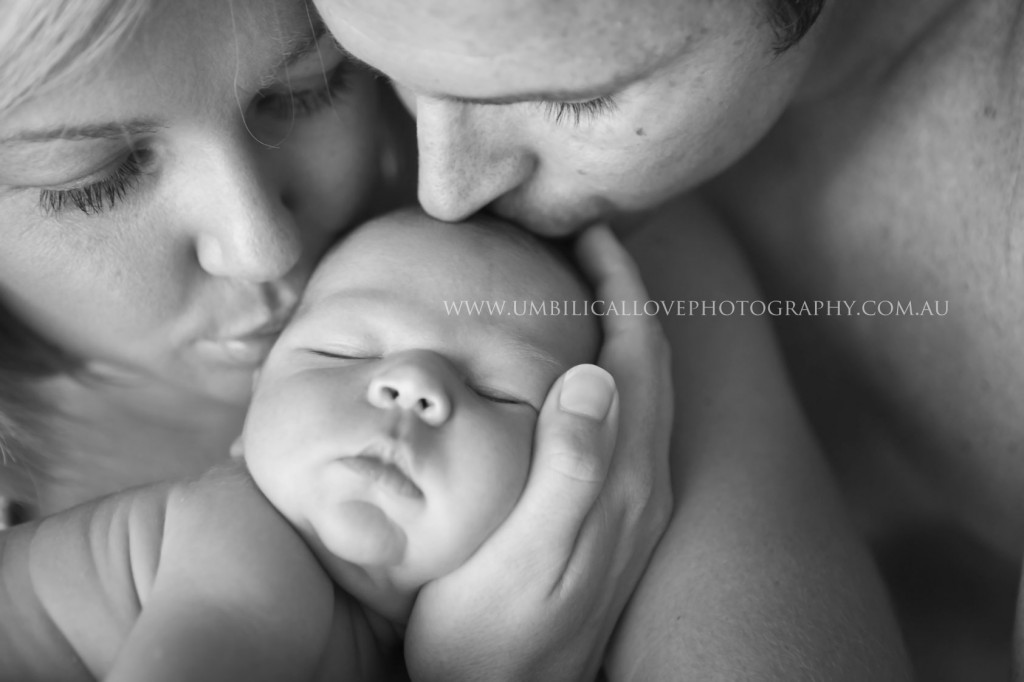 Professional Baby & Family Photos Wodonga & Albury mum and dad holding and kissing their 7 days old baby