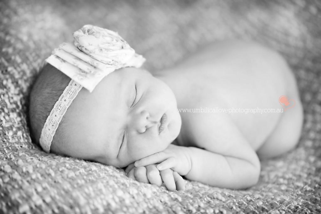 baby sleeping with a gorgeous bow headband on