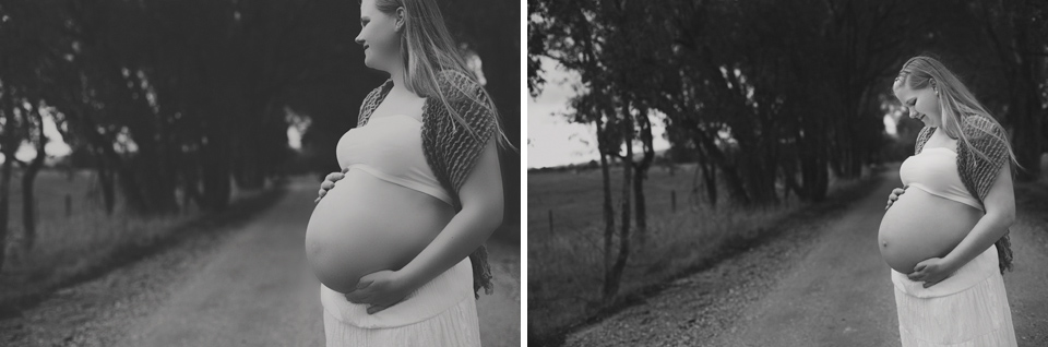 pregnant lady looking out the side holding her pregnant belly
