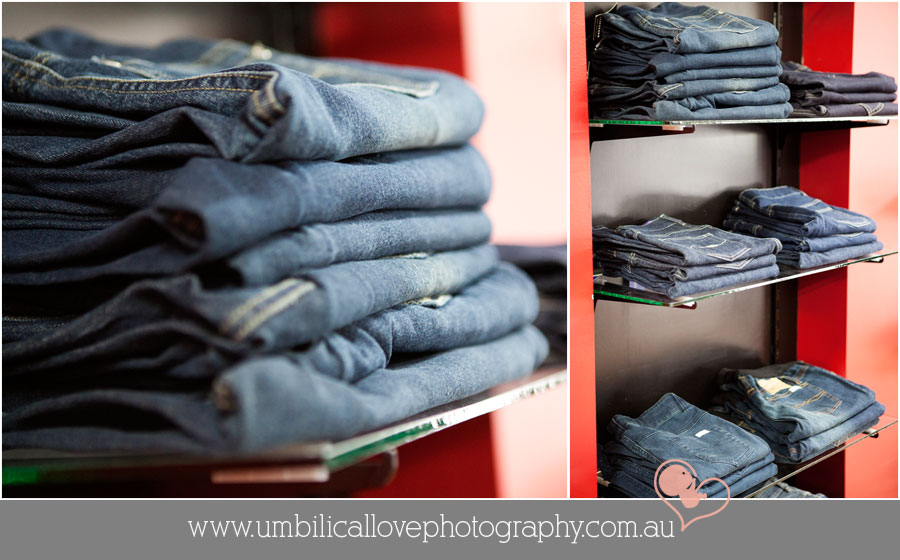 expandable jeans for maternity wear sitting in a stack on shelf
